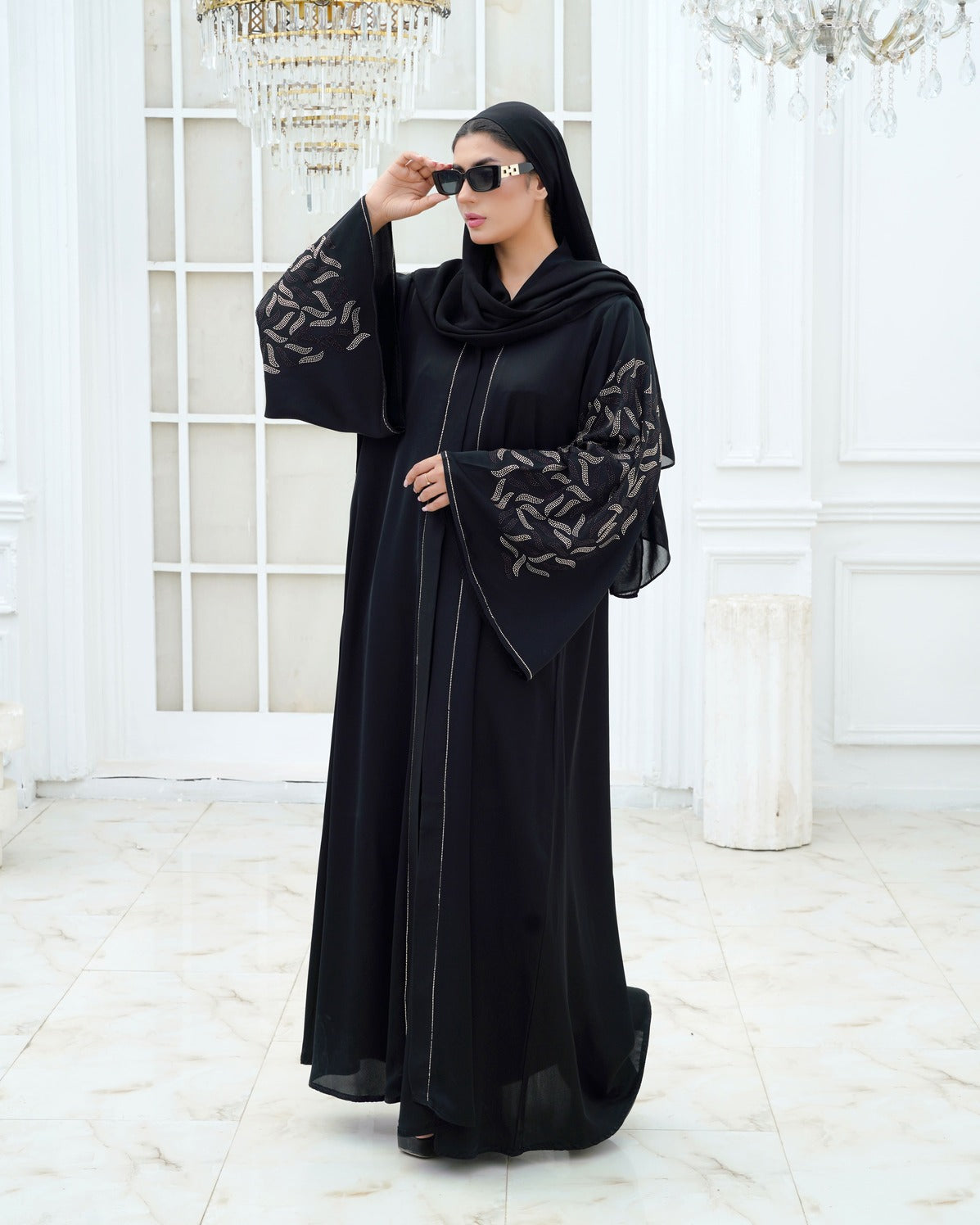 Women wearing embroidered black abaya by Zeenat